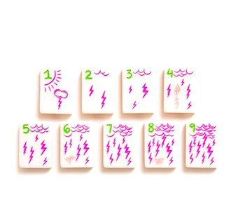 Mahjong tiles with pink and green motifs