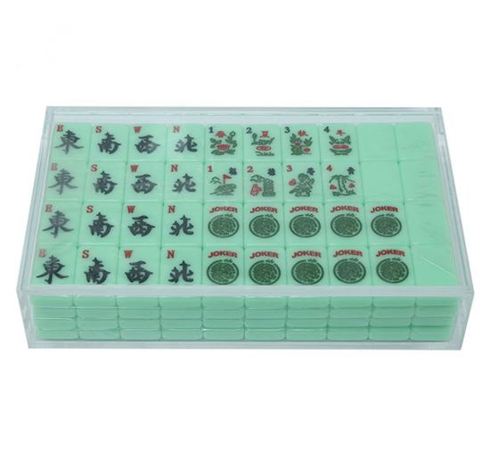 Green mahjong tile collection in a clear acrylic case